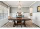 Elegant dining room features a wooden table, neutral walls, and a stylish light fixture at 1450 Rainfall Ct, Cumming, GA 30040