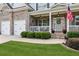 Charming front porch with white railings and a gray front door with a decorative wreath, enhancing curb appeal at 1450 Rainfall Ct, Cumming, GA 30040