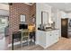 Home office nook with exposed brick wall and modern desk and storage at 1450 Rainfall Ct, Cumming, GA 30040