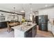 Open kitchen with granite counters, stainless appliances, and an eat-in dining area with exposed wood beams at 1450 Rainfall Ct, Cumming, GA 30040
