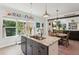 Bright kitchen with granite island, stainless appliances, and an eat-in dining area at 1450 Rainfall Ct, Cumming, GA 30040
