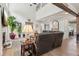 Bright living room with a fireplace, an exposed brick wall, and views of the dining area at 1450 Rainfall Ct, Cumming, GA 30040