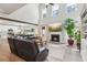 Open-concept living room with high ceilings, a fireplace, and a seamless flow to the kitchen at 1450 Rainfall Ct, Cumming, GA 30040