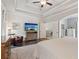 Large primary bedroom with trey ceilings, hardwood floors, and a TV for luxury relaxation at 1450 Rainfall Ct, Cumming, GA 30040