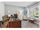 Bright home office featuring a large window, neutral walls, and comfortable seating at 1450 Rainfall Ct, Cumming, GA 30040