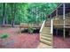 Two-tiered deck with wooden stairs leading to wooded backyard, great for enjoying nature at 23 Timberlake Pointe Ne, Cartersville, GA 30121