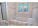 Bathroom showcasing a large soaking tub with jets and a shower with glass door near a window at 23 Timberlake Pointe Ne, Cartersville, GA 30121
