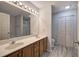 Bright bathroom with double sink vanity, updated flooring, and a separate room for toilet and linen closet at 23 Timberlake Pointe Ne, Cartersville, GA 30121