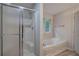 Bathroom featuring a tub, shower, and a window to provide ample natural lighting and open feel at 23 Timberlake Pointe Ne, Cartersville, GA 30121