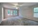 Spacious bedroom featuring neutral walls, plush carpeting, and natural light from multiple windows with wooded view at 23 Timberlake Pointe Ne, Cartersville, GA 30121