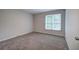Bedroom with neutral walls and plush carpeting and natural light from window at 23 Timberlake Pointe Ne, Cartersville, GA 30121
