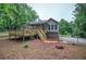 Exterior of a home with a tiered wooden deck surrounded by trees and a fenced perimeter at 23 Timberlake Pointe Ne, Cartersville, GA 30121