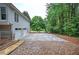 Side view of home with two-car garage and driveway, surrounded by lush greenery at 23 Timberlake Pointe Ne, Cartersville, GA 30121