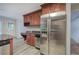 Kitchen with stainless steel refrigerator and wine rack storage in wood cabinets at 23 Timberlake Pointe Ne, Cartersville, GA 30121