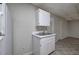 Compact kitchenette equipped with a double sink, white cabinets, and an electric outlet at 23 Timberlake Pointe Ne, Cartersville, GA 30121