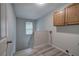 Laundry room with wood cabinets and luxury vinyl tile floor at 23 Timberlake Pointe Ne, Cartersville, GA 30121
