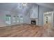 Bright living room with hardwood floors, stone fireplace, and French doors to the outdoor deck at 23 Timberlake Pointe Ne, Cartersville, GA 30121
