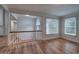 Bright open-concept living room with hardwood floors, staircase, and large windows for natural light at 23 Timberlake Pointe Ne, Cartersville, GA 30121