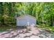 Detached garage with a double door and a single entry, surrounded by green trees at 3361 Myrtle St, Atlanta, GA 30354