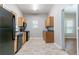 Kitchen with black appliances and light brown cabinetry and tile flooring at 3361 Myrtle St, Atlanta, GA 30354