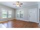 Hardwood flooring in the bright living room with a front door and updated windows at 3361 Myrtle St, Atlanta, GA 30354
