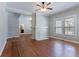 Open living room featuring hardwood floors, brick fireplace, large window, and a ceiling fan at 3361 Myrtle St, Atlanta, GA 30354