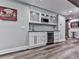 Modern bar area with wine cooler, white cabinets, and granite countertops at 5039 Towne Lake Hills North, Woodstock, GA 30189