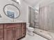 Modern bathroom features a glass enclosed shower, sleek vanity, and neutral tiling at 5039 Towne Lake Hills North, Woodstock, GA 30189