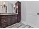 Modern bathroom vanity with dark cabinets, elegant fixtures, and stylish tile flooring at 5039 Towne Lake Hills North, Woodstock, GA 30189