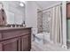Bathroom features a vanity, shower with stylish tile, and neutral decor at 5039 Towne Lake Hills North, Woodstock, GA 30189