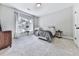 Cozy bedroom showcases a large window, comfortable bed, and neutral color palette at 5039 Towne Lake Hills North, Woodstock, GA 30189