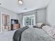Bright bedroom features a plush bed, large window with curtains, and an ensuite bathroom at 5039 Towne Lake Hills North, Woodstock, GA 30189