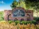 Welcome to Towne Lake Hills, beautifully marked by this brick entrance amidst lush landscaping at 5039 Towne Lake Hills North, Woodstock, GA 30189