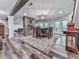 Open dining area features stone fireplace, modern lighting, and wood floors at 5039 Towne Lake Hills North, Woodstock, GA 30189
