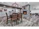 Open dining area with stone fireplace, modern lighting, and bar area at 5039 Towne Lake Hills North, Woodstock, GA 30189