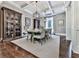 Formal dining room featuring hardwood floors, coffered ceilings, statement chandeliers, and a neutral color palette at 5039 Towne Lake Hills North, Woodstock, GA 30189