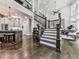 Elegant foyer with grand staircase, hardwood floors, and open layout connecting to kitchen and living areas at 5039 Towne Lake Hills North, Woodstock, GA 30189