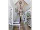 Stunning foyer with grand staircase, hardwood floors, and elegant lighting fixture at 5039 Towne Lake Hills North, Woodstock, GA 30189
