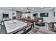 Spacious game room with air hockey table, foosball, and large screen TVs at 5039 Towne Lake Hills North, Woodstock, GA 30189