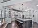 Spacious kitchen with a large island, white cabinets, pendant lighting, and hardwood floors at 5039 Towne Lake Hills North, Woodstock, GA 30189