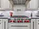 Close up of the kitchen featuring a stainless steel oven with red nobs and ample counter space at 5039 Towne Lake Hills North, Woodstock, GA 30189