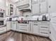 Charming kitchen with white cabinets, subway tile backsplash, stainless steel appliances, and dark hardwood floors at 5039 Towne Lake Hills North, Woodstock, GA 30189
