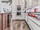 Stylish kitchen with stainless steel appliances, white cabinets, hardwood floors, and modern fixtures at 5039 Towne Lake Hills North, Woodstock, GA 30189