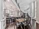 Open-concept kitchen and dining area featuring an island with seating, stainless steel appliances, and hardwood floors at 5039 Towne Lake Hills North, Woodstock, GA 30189