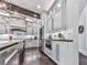 Contemporary kitchen featuring white cabinets, stainless steel appliances, under cabinet lighting, and dark wood floors at 5039 Towne Lake Hills North, Woodstock, GA 30189