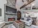 Beautiful living room featuring a stone fireplace and open floor plan at 5039 Towne Lake Hills North, Woodstock, GA 30189