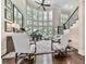 Elegant living room with floor-to-ceiling windows, a grand piano, and stylish decor at 5039 Towne Lake Hills North, Woodstock, GA 30189