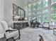 Elegant living room with floor-to-ceiling windows, a grand piano, and stylish decor at 5039 Towne Lake Hills North, Woodstock, GA 30189