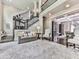 Comfortable living room area with plush carpet and a staircase featuring wrought iron at 5039 Towne Lake Hills North, Woodstock, GA 30189