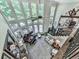 Upper view of a luxury living room with a piano, large windows, and a staircase at 5039 Towne Lake Hills North, Woodstock, GA 30189